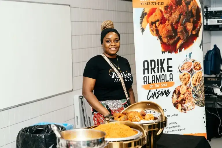 A local African cuisine caterer serving guests at a Bridge Alliance Canada event
