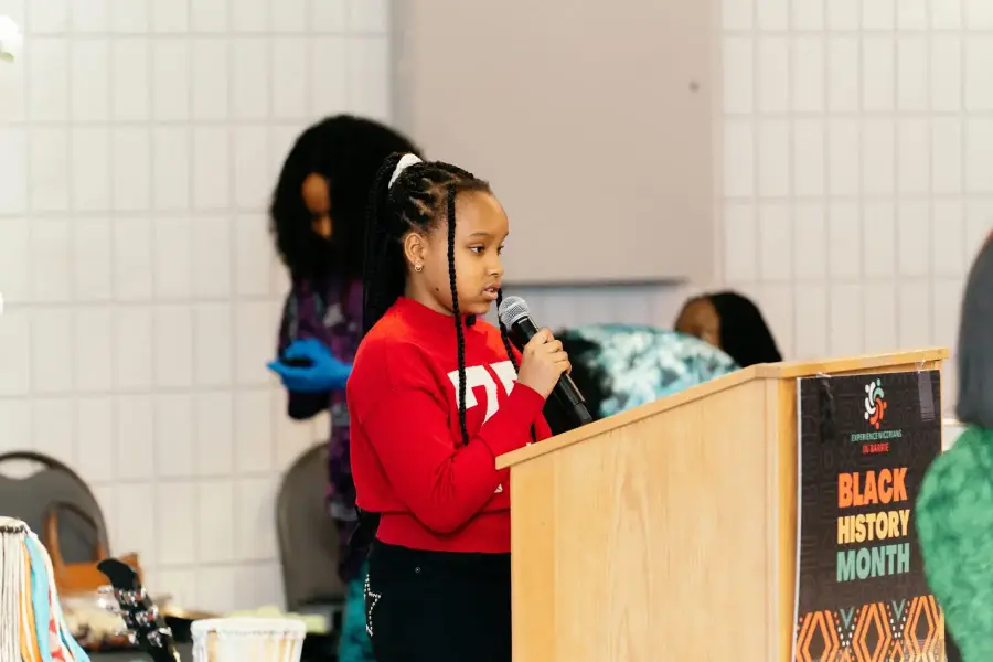 A young speaker at the podium during Black History Month in Barrie